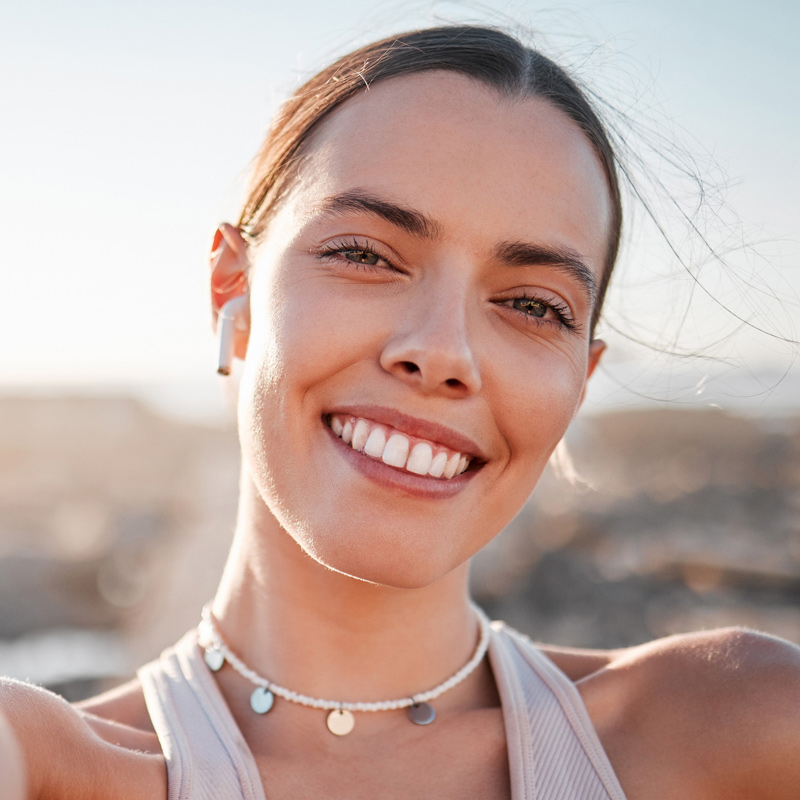 Silhouette of a woman's profile with an aura of colors around her face.